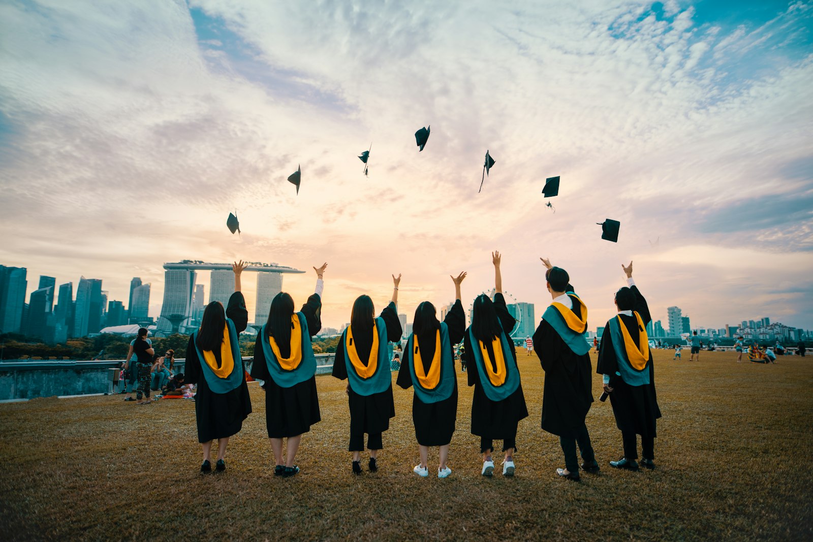 Graduate in cap and gown ascending stone steps