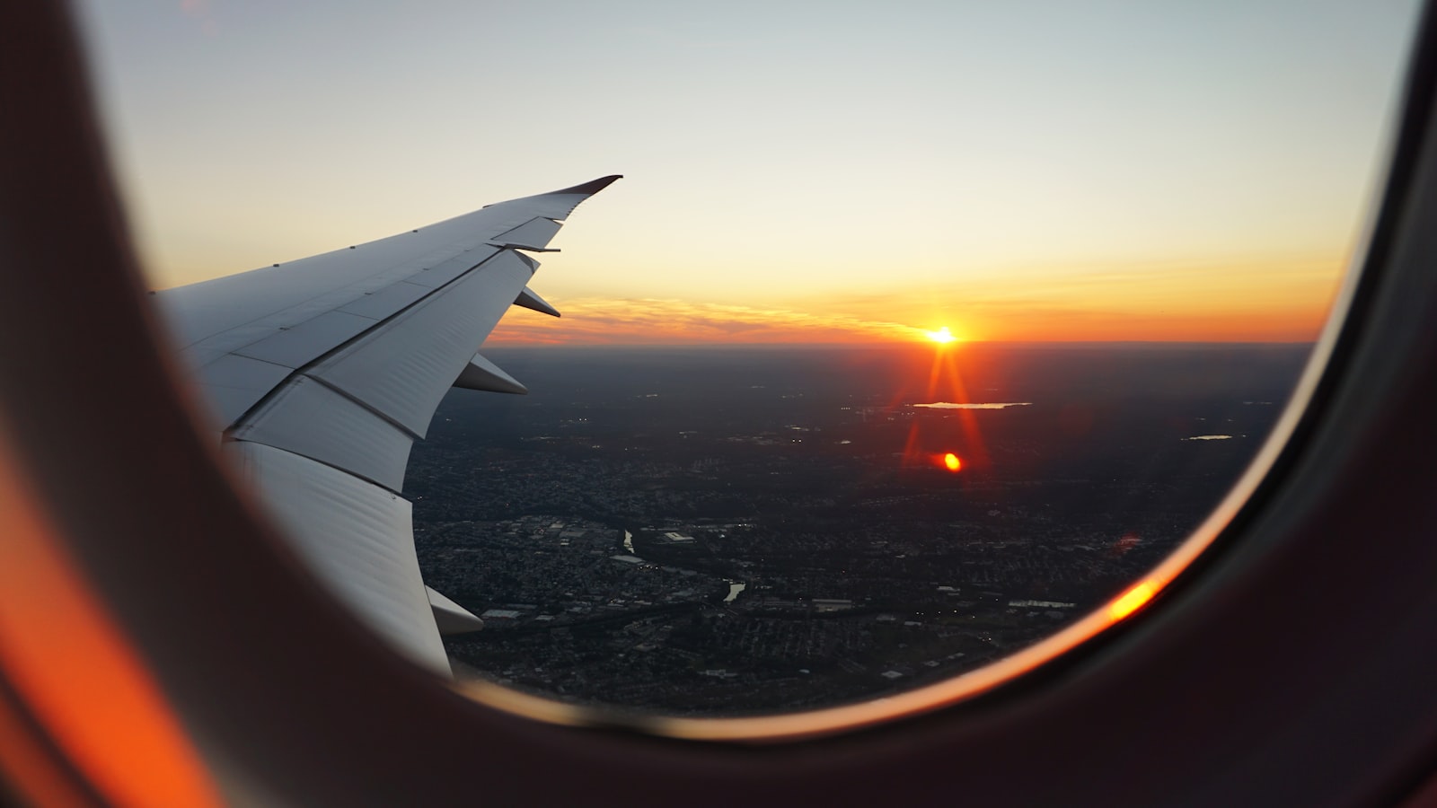 View from an airplane window over the clouds